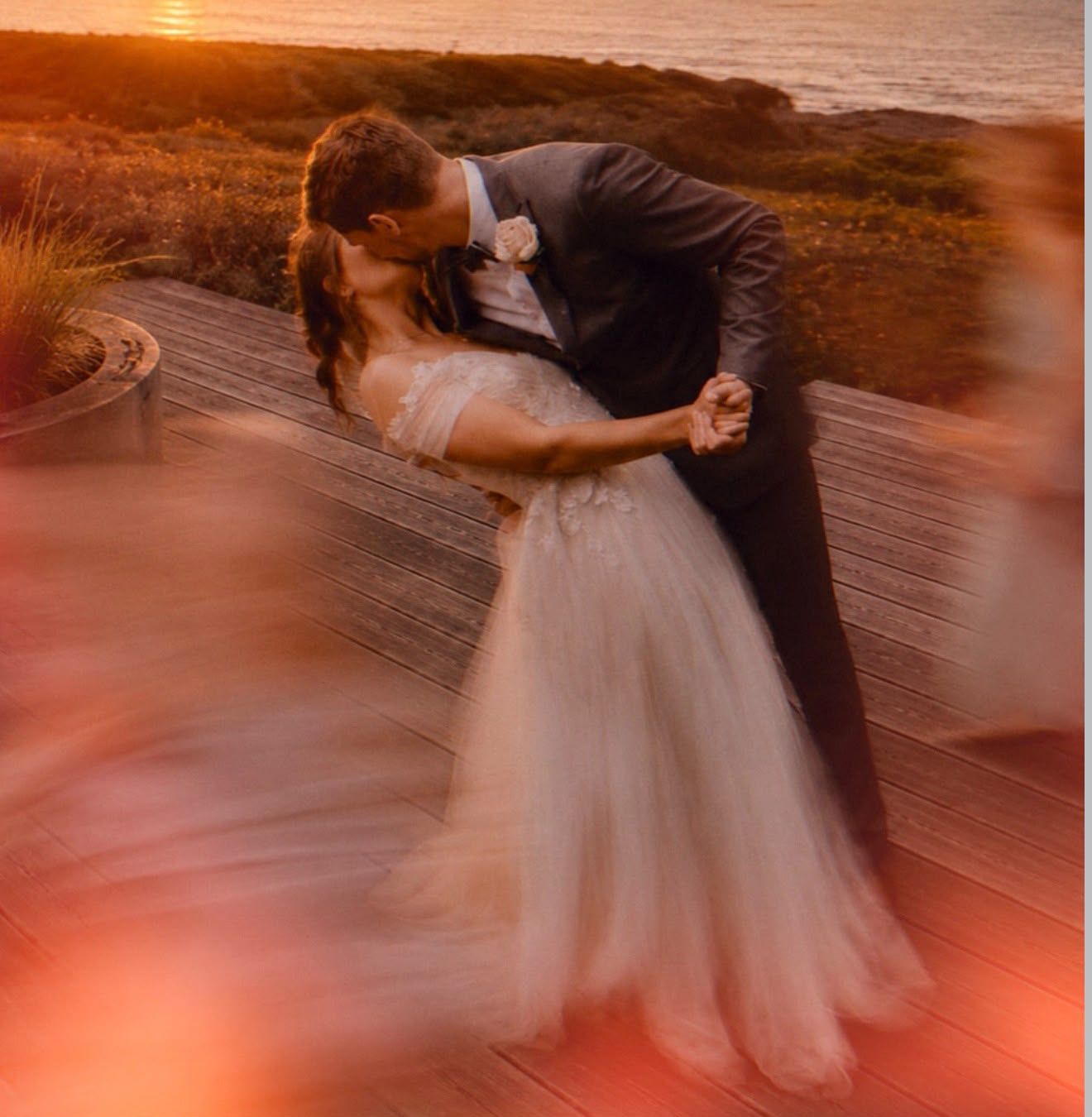 Couple dancing on the deck at sunset
